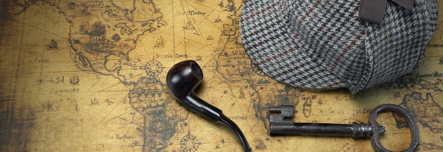 A pipe and hat on top of a map.