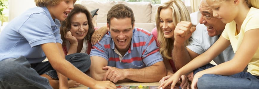 Three people are playing a board game together.
